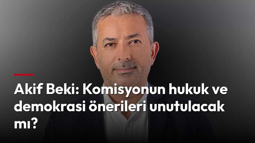 Akif Beki, koyu renk ceket ve beyaz gömlekle kameraya bakıyor.