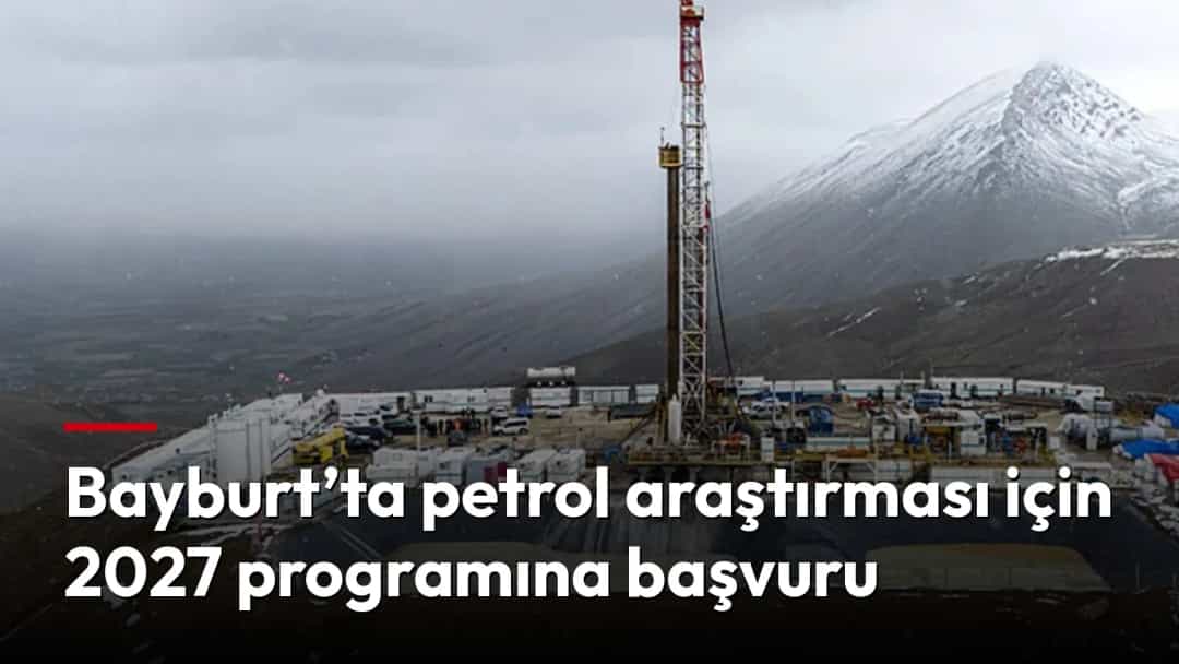 Karlı dağların eteklerinde kurulu petrol sondaj sahası ve yükselen sondaj kulesi.