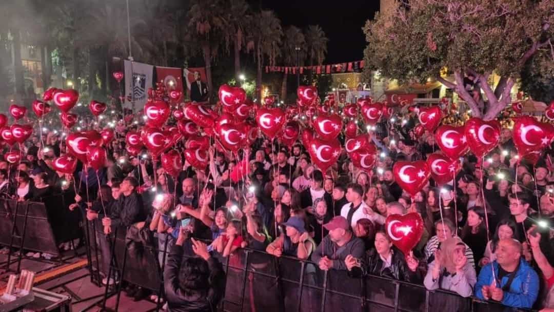 Bodrum'da bayram kutlamasında Türk bayraklı balonlar taşıyan kalabalık.