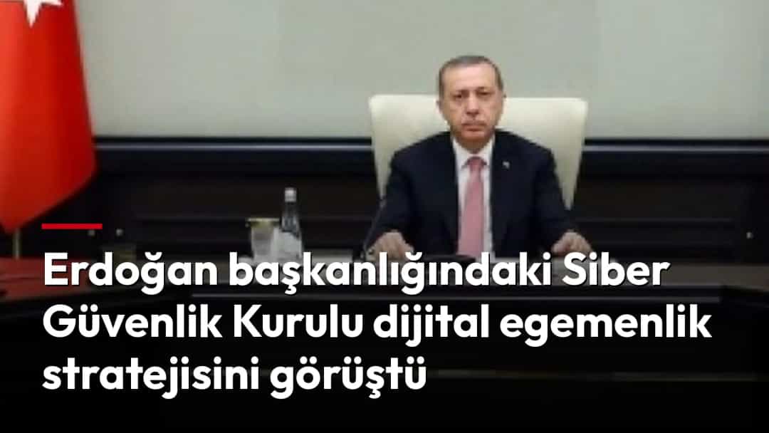 Recep Tayyip Erdoğan, Türk bayrakları ve Atatürk portresi önünde toplantı masasında oturuyor.