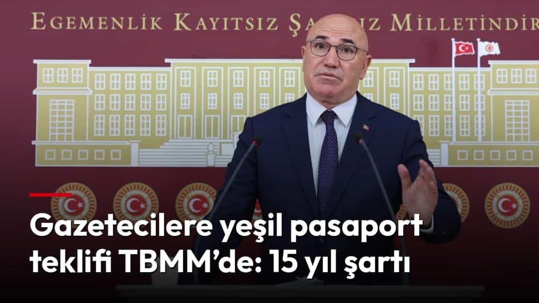 Mahmut Tanal, TBMM amblemi önünde kürsüde konuşuyor.