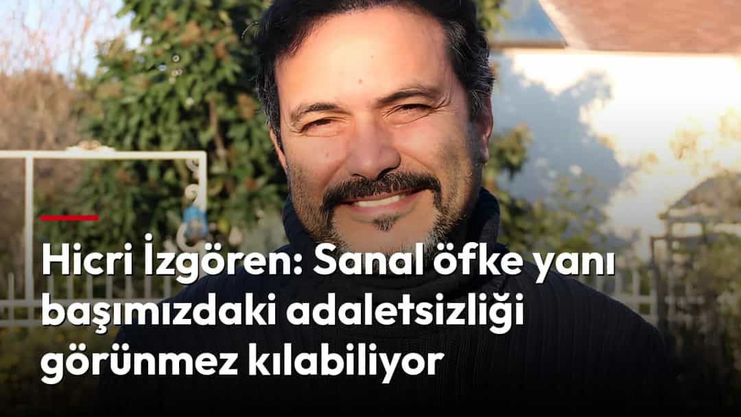 Hicri İzgören, açık havada siyah boğazlı kazakla gülümserken.
