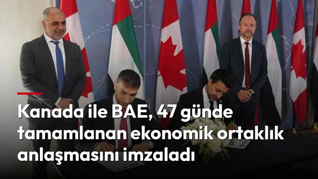 Kanada ve BAE bayraklarının önünde iki yetkili ekonomik ortaklık anlaşmasını imzalıyor.