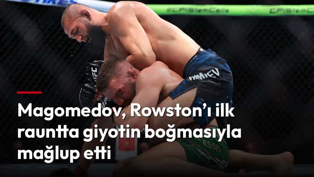 Abus Magomedov rakibini kafes içinde yerde kontrol ederken.
