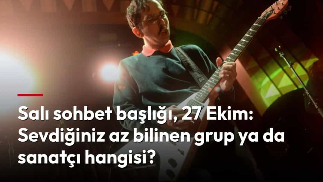 Sahne ışıkları altında elektro gitar çalan bir müzisyen.