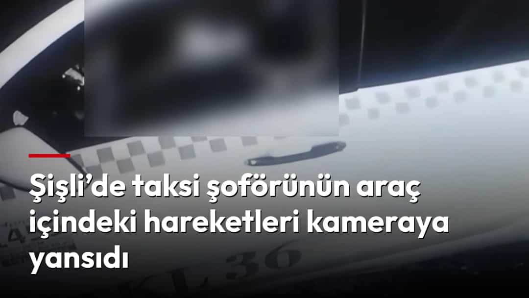 Taksinin içinden, araç kabinini ve ön bölümde bulanıklaştırılmış bir alanı gösteren görüntü.