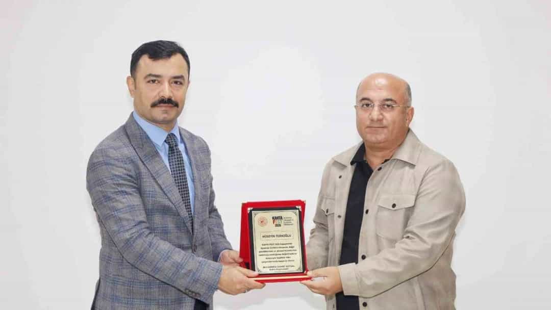 Kahta Kaymakamı Soysal, İHA muhabiri Türkoğlu’na KAHTAFEST 2026 plaketi verirken
