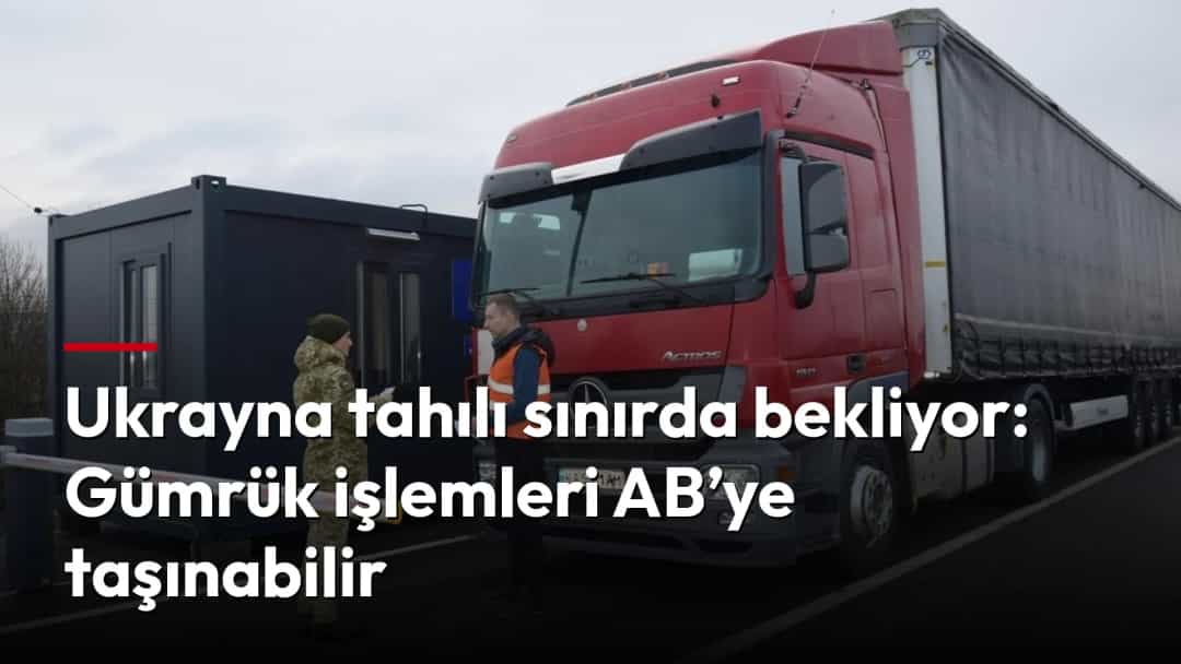 Sınır kontrol noktasında bir görevli, gümrük işlemleri için bekleyen tırın yanında duruyor.